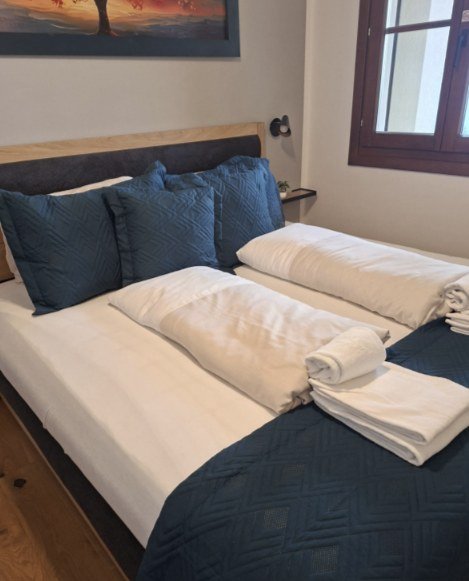 Schlafzimmer mit Doppelbett und Fenster – Ferienwohnung Alpennest, Gerlitzen Alpe